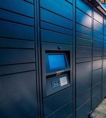 a row of blue lockers with a computer screen in the middle